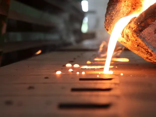 Iron molten metal pouring in sand mold_