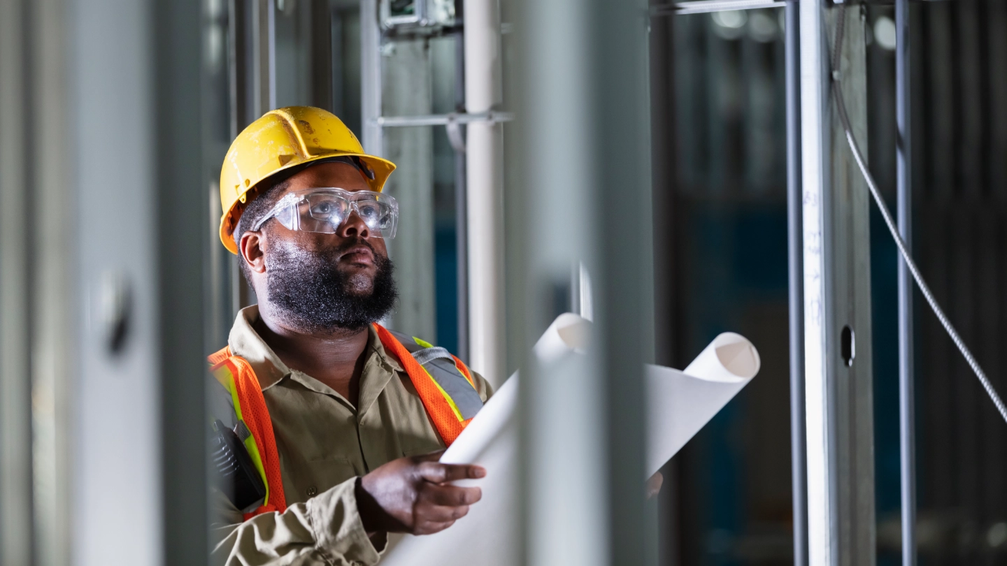 construction worker reviewing drawings construction worker reviewing drawings