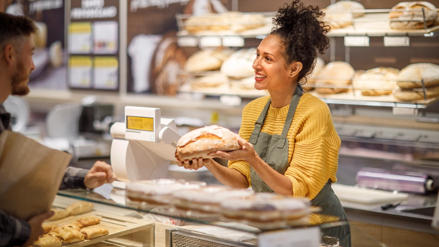 Woman selling bread at a bakery Woman selling bread at a bakery