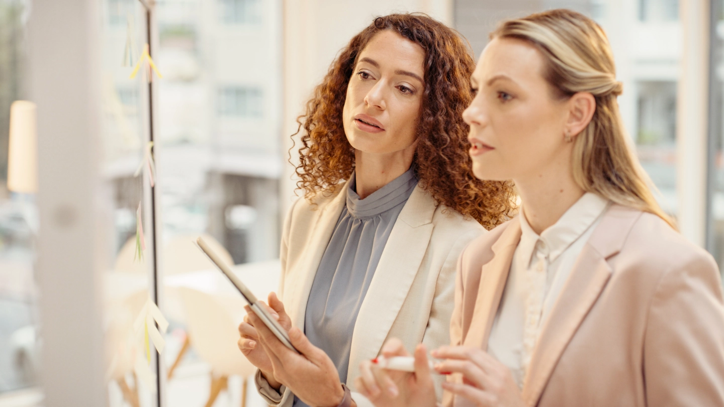 two women at a board two women at a board
